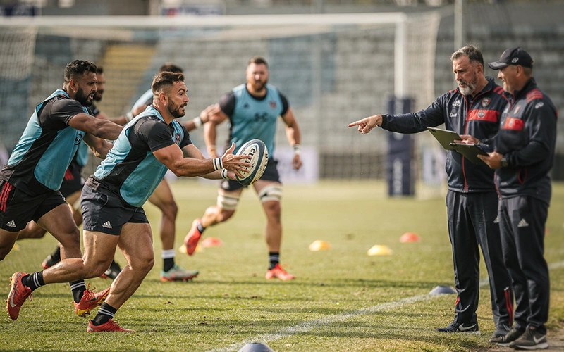 Rugby team squad training session with coaching staff reviewing player fitness and selection